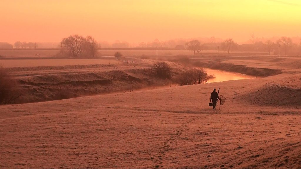A frosty pike fishing sunrise scene besides a river from Caught In The Act