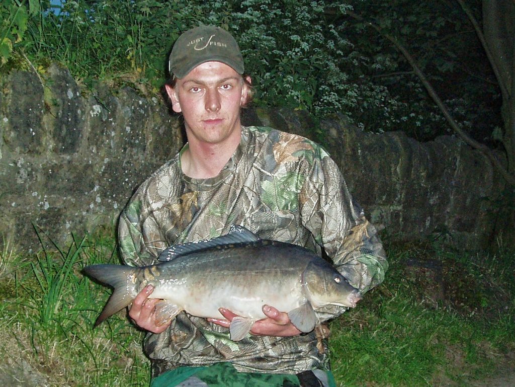 12lb mirror carp caught on the surface using an artificial floating dog biscuit bait. 